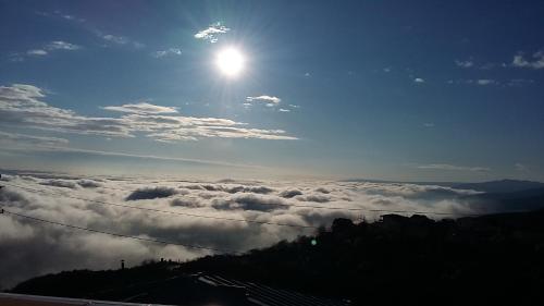 a view of the sun rising above the clouds at Guest House Maria in Sighnaghi