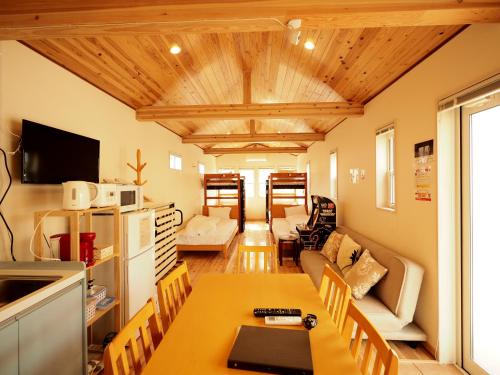 a kitchen and living room with a table and a couch at Bath in Beppu