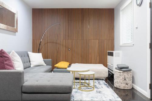 a living room with a couch and a table at Victorian Retreat 2Bed, 1Bath, Parking, Game Room in Oakland
