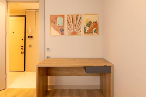 a wooden desk in a room with paintings on the wall at Los Suites in Antalya