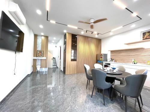 a dining room with a table and chairs at Novaworld Phan Thiết in Bình Tú