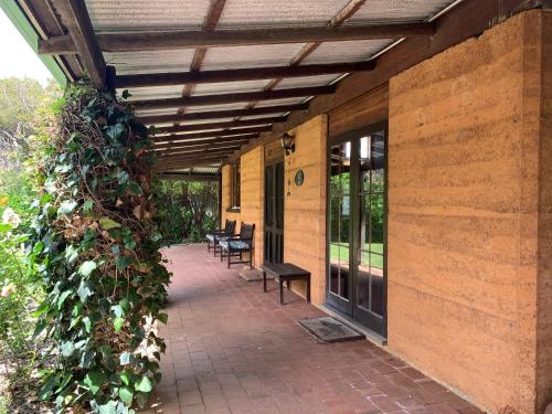 a patio with awning and benches on a building at Tea Tree - Pet Friendly - Prevelly - Margaret River in Margaret River Town