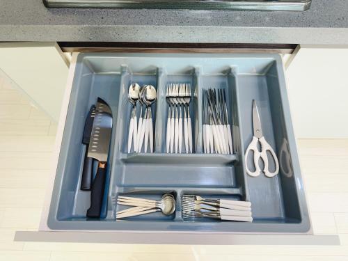 a blue tray filled with utensils in a drawer at Mirinae in Seoul