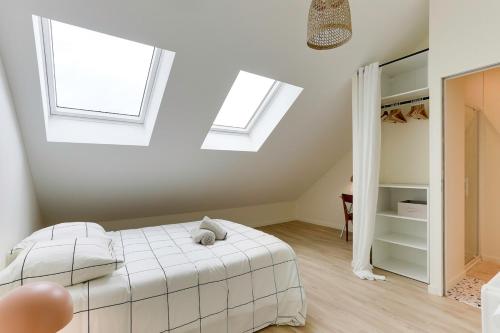 a bedroom with a bed and two skylights at Maison Joseph - Suite 2 in Saint-Jacques-de-la-Lande