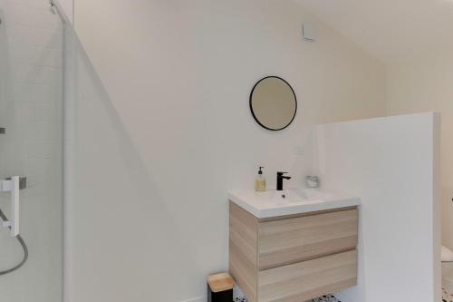 a bathroom with a sink and a mirror at Maison Joseph - Suite 2 in Saint-Jacques-de-la-Lande