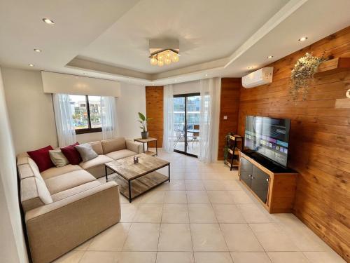 a living room with a couch and a tv at Spacious 3-Bedroom Apartment in Limassol in Limassol