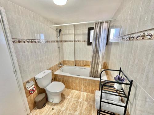 a bathroom with a toilet and a bath tub at Spacious 3-Bedroom Apartment in Limassol in Limassol