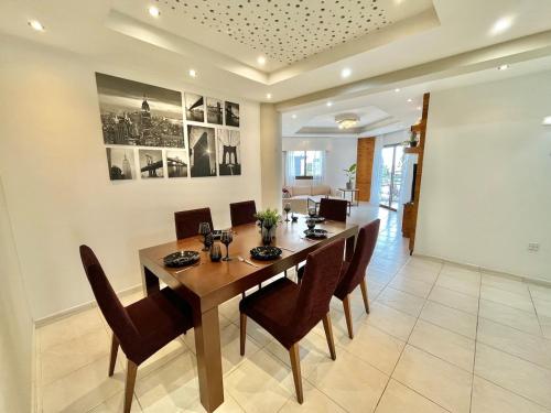 a dining room with a large wooden table and chairs at Spacious 3-Bedroom Apartment in Limassol in Limassol