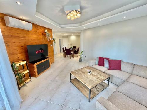 a living room with a couch and a table at Spacious 3-Bedroom Apartment in Limassol in Limassol