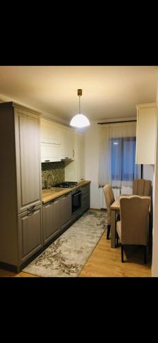 a kitchen and dining room with a table and chairs at Colibri Rezident! in Galaţi
