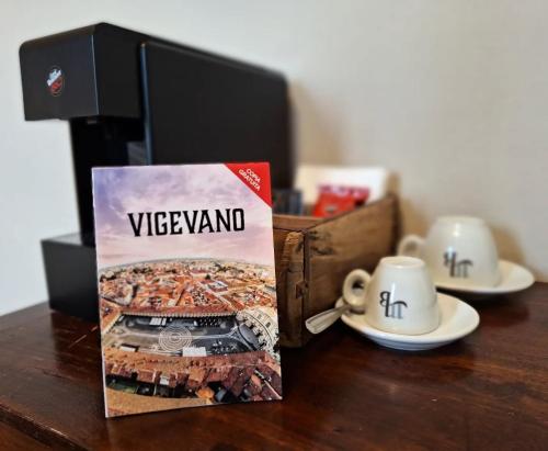 a book sitting on a table next to a cup of coffee at Cascina Mora Bassa in Vigevano