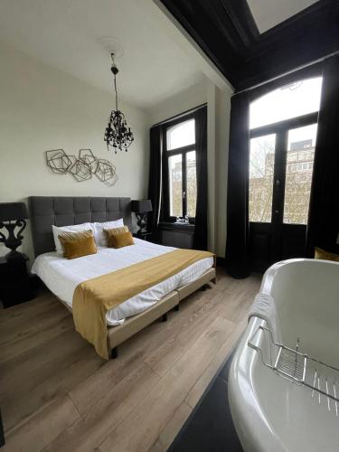 a bedroom with a bed and a sink and a tub at B in Antwerp in Antwerp