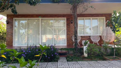 a home with a garden with purple flowers at Huyen's Home in Ba Ria