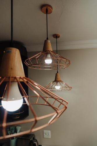 a group of three lights hanging from a ceiling at Forest Hill Wilderness in Wilderness