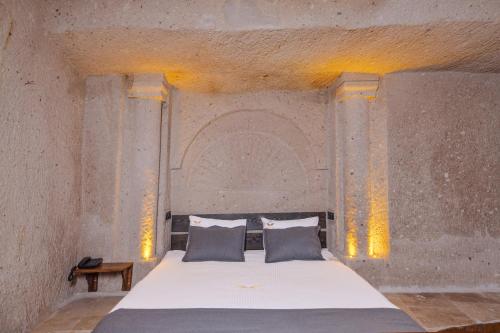 a bedroom with a large bed with two pillows at Angel View Suites in Goreme