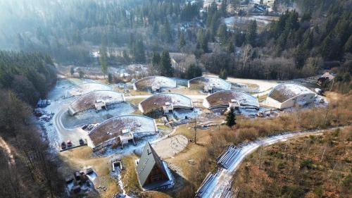 an aerial view of a resort with a river and domes at Apartments Relax Tále in Evergreen Resort in Tale