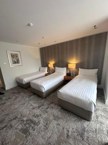 a hotel room with two beds and two lamps at Residence on Langley Park in Perth