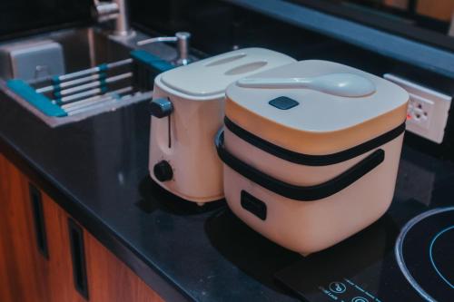 two toasters sitting on top of a counter at SureStay Studio by Best Western Clarkview Angeles City in Angeles