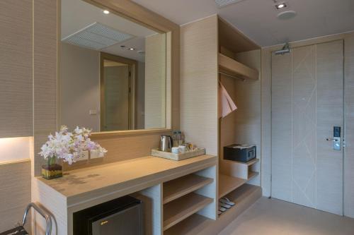 a bathroom with a sink and a mirror at Panan Krabi Resort in Ao Nang Beach