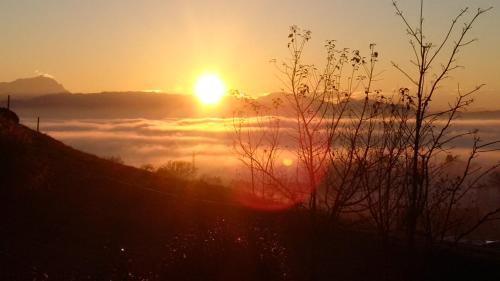 a sunset with the sun rising above the clouds at F E R I E N W O H N U N G "Am Halbenstein" in Hörbranz