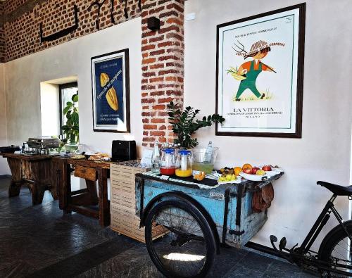 a kitchen with a table and a bike in a room at Cascina Mora Bassa in Vigevano