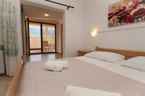 a bedroom with a bed with two pillows on it at Apartments Petrica in Baška