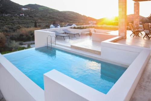 a pool on the roof of a house at Amorelia Casa in Lefkogeia