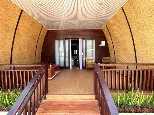 an external view of a building with a wooden walkway at Bayview Beach Resort East Lombok in Labuan Lombok