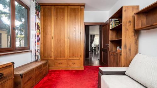 a living room with a couch and a red carpet at Wołodyjowskiego - Mokotów with jacuzzi, Sun & Snow in Warsaw