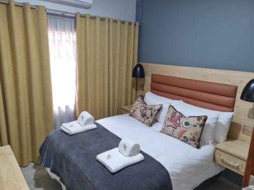a bedroom with a bed with towels on top of it at Blyde Canyon, A Forever Resort in Matibidi
