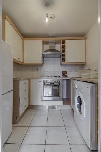 a kitchen with a washing machine and a washer at Perfect for construction workers and building contractors in Manchester
