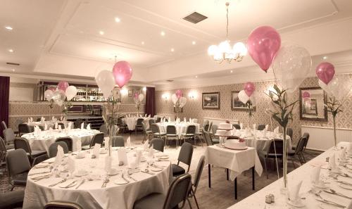 a dining room filled with tables and chairs at Burnett Arms Hotel in Banchory