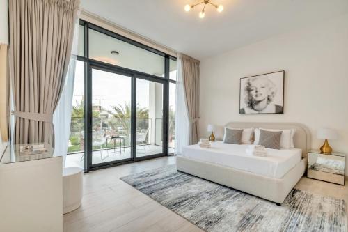 a bedroom with a white bed and a large window at Dubai Luxury 4BR Villa in Murooj Al Furjan in Dubai