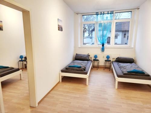a room with two beds and a window at Apartment in Herzogenrath-Merkstein in Herzogenrath