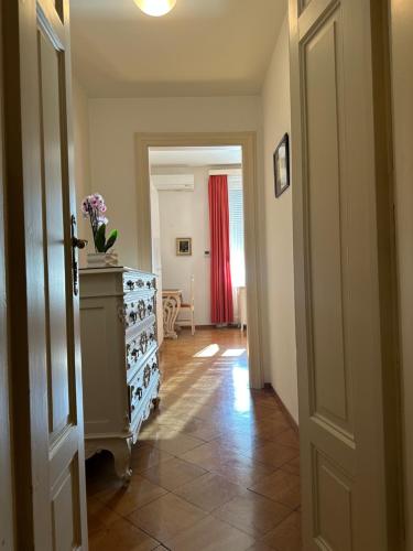 a hallway with a dresser and a red curtain at Casa Santa Birgitta in Lugano