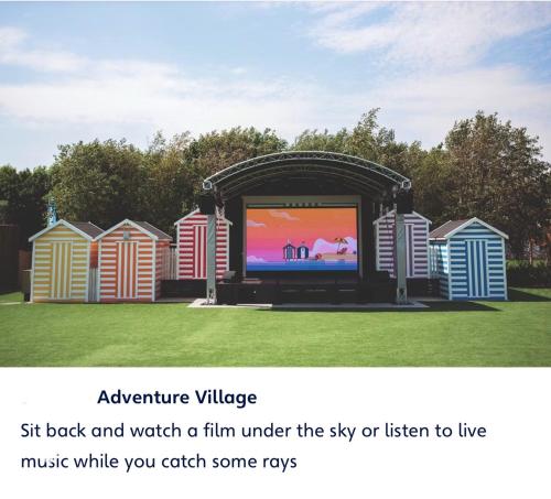 a large screen tv in a park with houses at Haven cleethorpes beach holiday park in Cleethorpes
