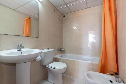 ein Badezimmer mit Toilette, Waschbecken und Badewanne in der Unterkunft Catalonia Park Apartamentos in Salou