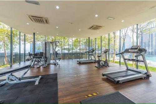 a gym with several treadmills and elliptical machines at Dorsett Residences Bukit Bintang in Kuala Lumpur
