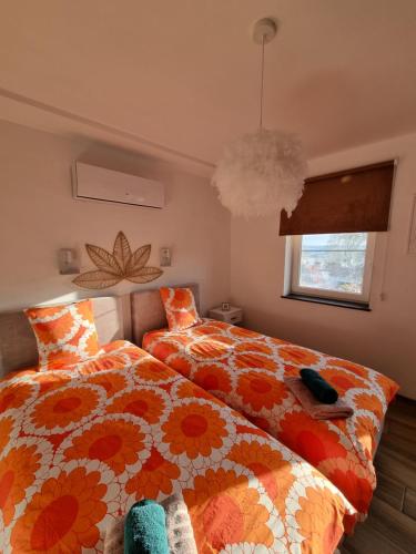 a bedroom with two beds and a window at Cerf, ouvre-moi B&B in Rochefort