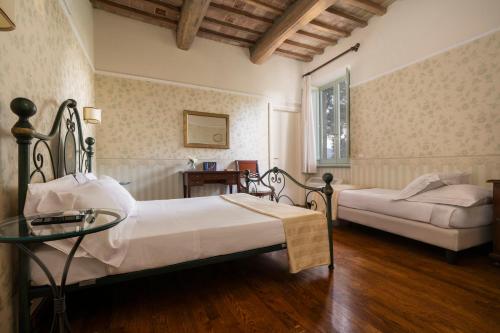 Postel nebo postele na pokoji v ubytování Relais Parco Dei Cavalieri Assisi