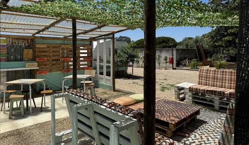 an outdoor patio with a pergola and a table and chairs at Vdb Lodge - coworking space - Work Relax & Sleep in Sobreda