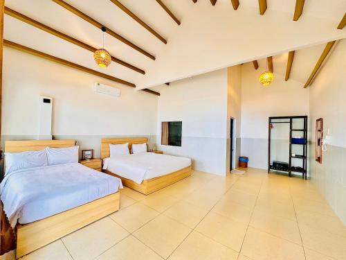 a bedroom with two beds and a tv at Paradise Resort Doc Let - All Inclusive in Doc Let