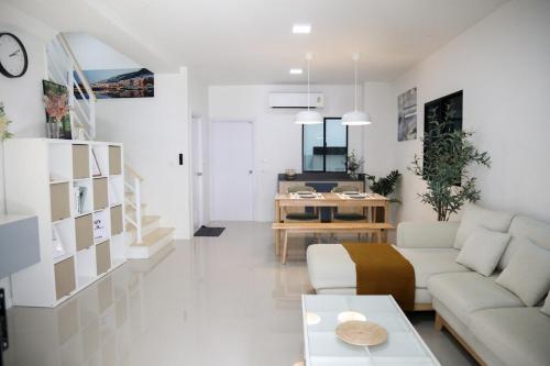 a living room with a couch and a table at Cozy Homey Place Townhome in Bangkok