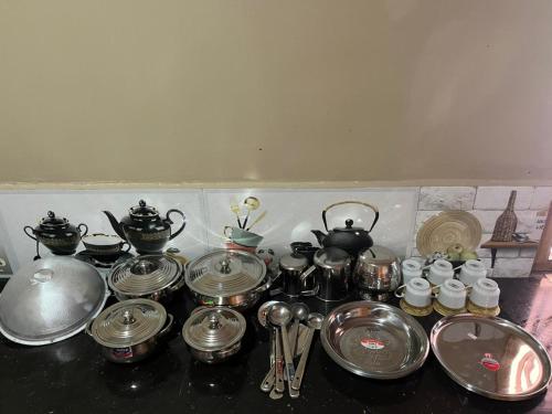 a bunch of utensils and pots and pans on a counter at Right Choice House in Vaddakkachchi