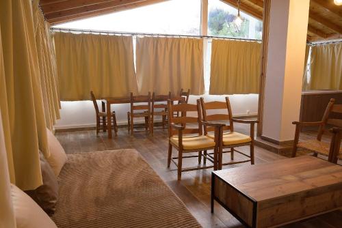a dining room with a table and chairs and a window at Aphrodite Apartment Near The Beach and The Airport in Áyios Spirídhon