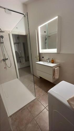 a bathroom with a shower and a sink and a mirror at Sole e Lago in Stresa
