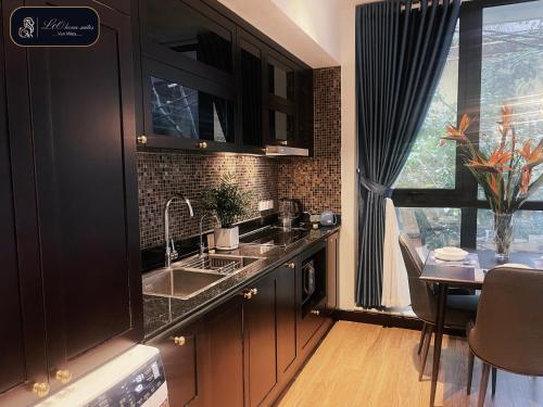 a kitchen with a sink and a table and a window at High-ser Apartment -2BR - NiceView - Parking - Spacious - In center in Hanoi