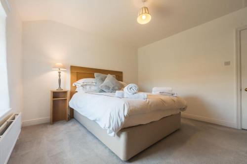 a bedroom with a bed with towels on it at Two Trees, By Birch Stays in Hetton