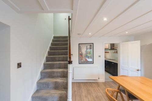 a staircase in a home with a table and a dining room at Two Trees, By Birch Stays in Hetton
