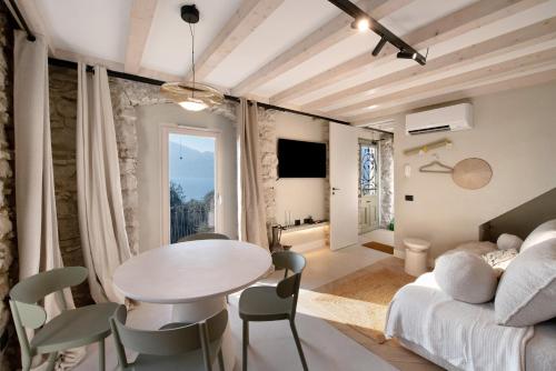 a living room with a table and a couch at Cozy Sommavilla Residence in Brenzone sul Garda